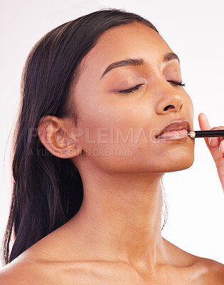 Buy stock photo Beauty, makeup and pencil on face of woman in studio for cosmetics, lip liner and product. Salon, self care and glow with female model on white background for application, lipstick and facial 