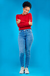 Fashion, smile and portrait of a woman with comfort and confident isolated in a studio blue background. Casual, calm and full body of a happy young female person with stylish or trendy clothes