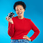 Photographer woman, thinking and camera in studio for photoshoot, memory and magazine by blue background. Young journalist girl, retro tech and lens for paparazzi, newspaper or content creator job