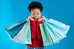 African woman, shopping bag or thinking in studio with wow, discount or sale by blue background. Gen z girl, student and shock with retail addiction, doubt or ideas for commercial customer experience