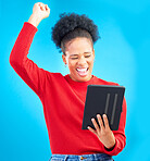 Happy woman, tablet and fist pump for winning, discount or sale against a blue studio background. Excited female person in celebration with technology for good news, bonus promotion or lottery prize