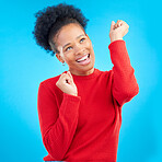 Happy woman, fist pump and celebration for winning, discount or sale against a blue studio background. Excited female person for good news, bonus promotion or lottery prize in reward or competition