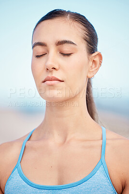 Buy stock photo Calm, fitness and woman at beach for meditation, training the mind and exercise for zen. Yoga, nature and face of a young girl with peace during a wellness and spiritual workout at the sea to relax