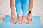 Hands, feet and yoga with a woman at the beach for fitness, wellness or health outdoor in the fresh air. Exercise, nature and relax with a female person stretching on the coast for pilates training