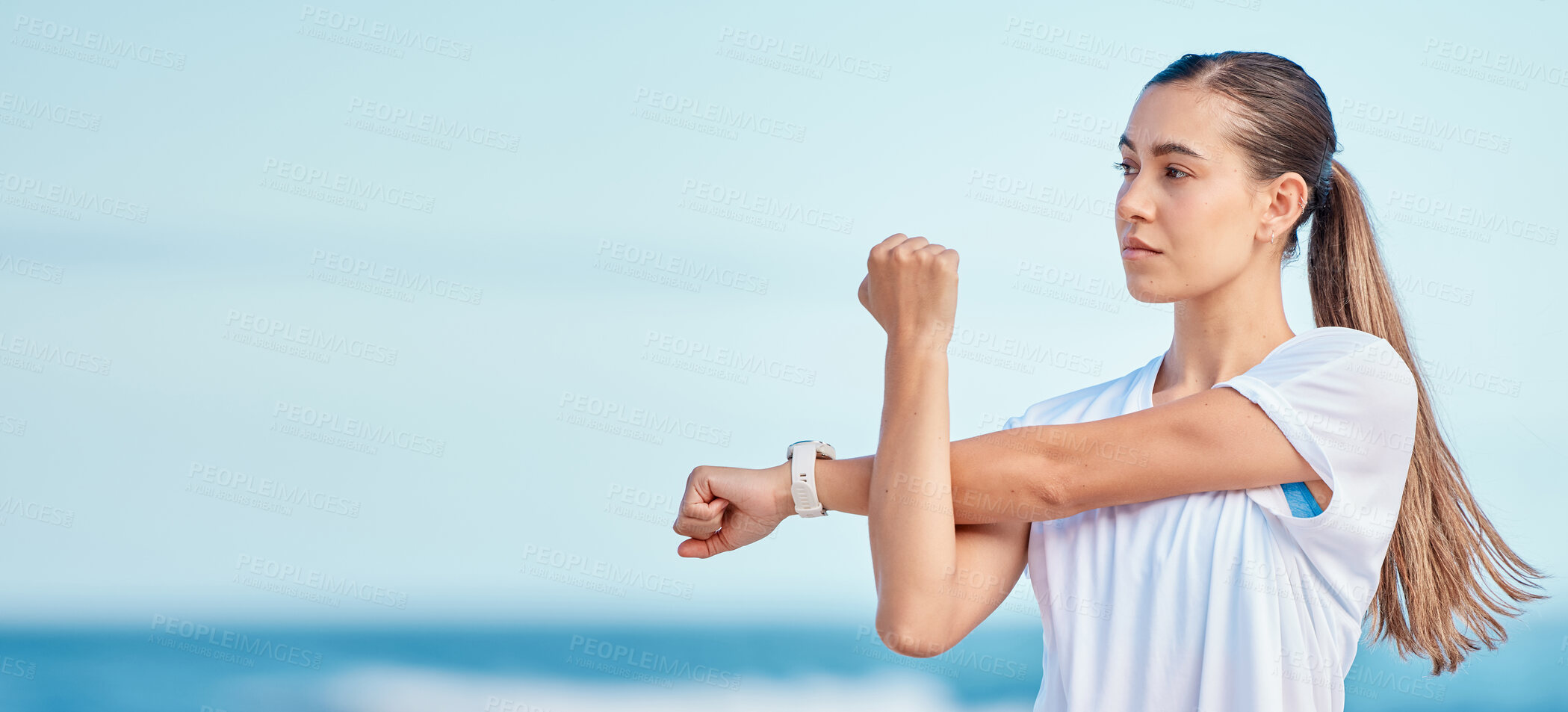 Buy stock photo Woman, arm and stretching by beach on mockup space in fitness, motivation or outdoor workout. Female person or runner in body warm up on ocean coast, banner or sports for healthy wellness or training