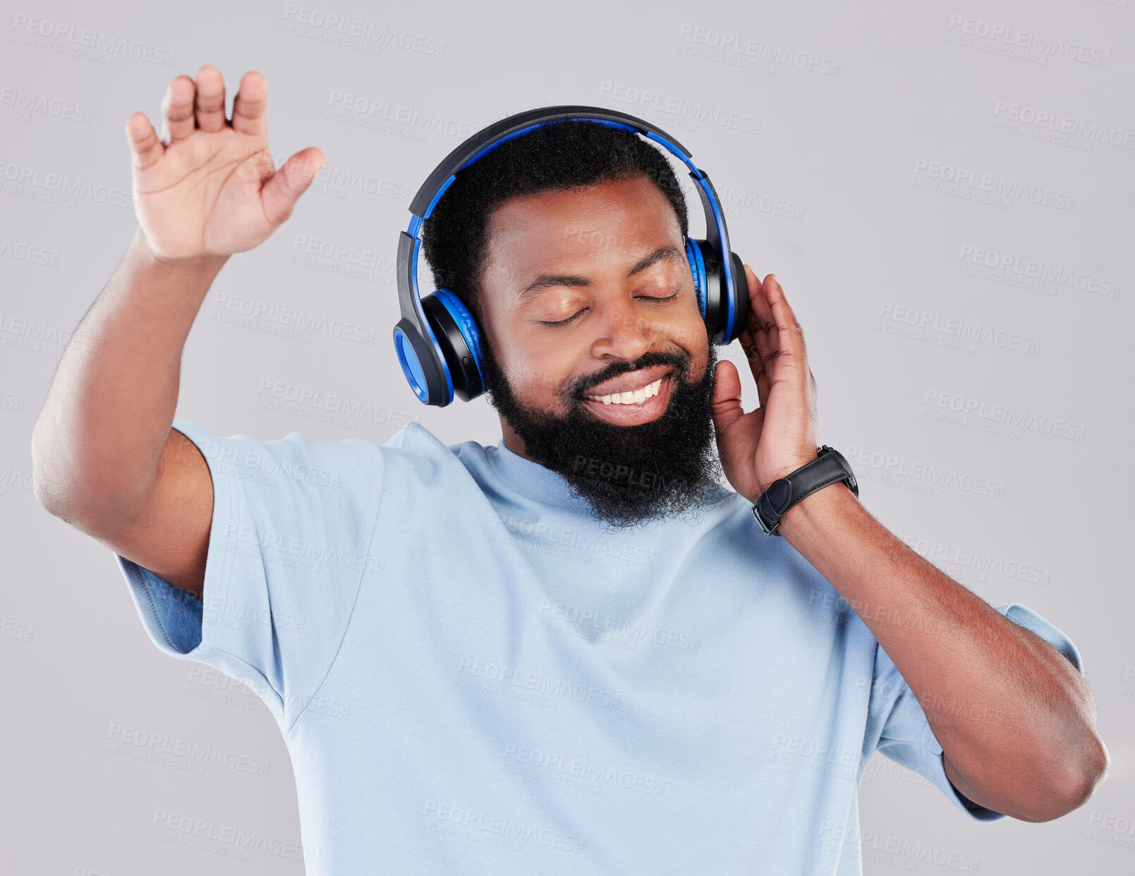 Buy stock photo Headphones, dance and man in a studio with music, playlist or album with a calm mindset. Happy, smile and young African male model streaming a song or radio online isolated by a gray background.