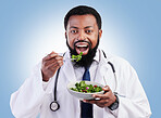 Doctor studio portrait, black man and salad to lose weight, vegan healthcare diet or healthy food benefits for clean eating. Green lettuce bowl, hungry or African male nutritionist on blue background