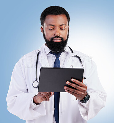 Buy stock photo Healthcare, tablet and a black man doctor in studio on a blue background for cardiology research. Medical, technology and innovation with a male medicine professional searching for information online