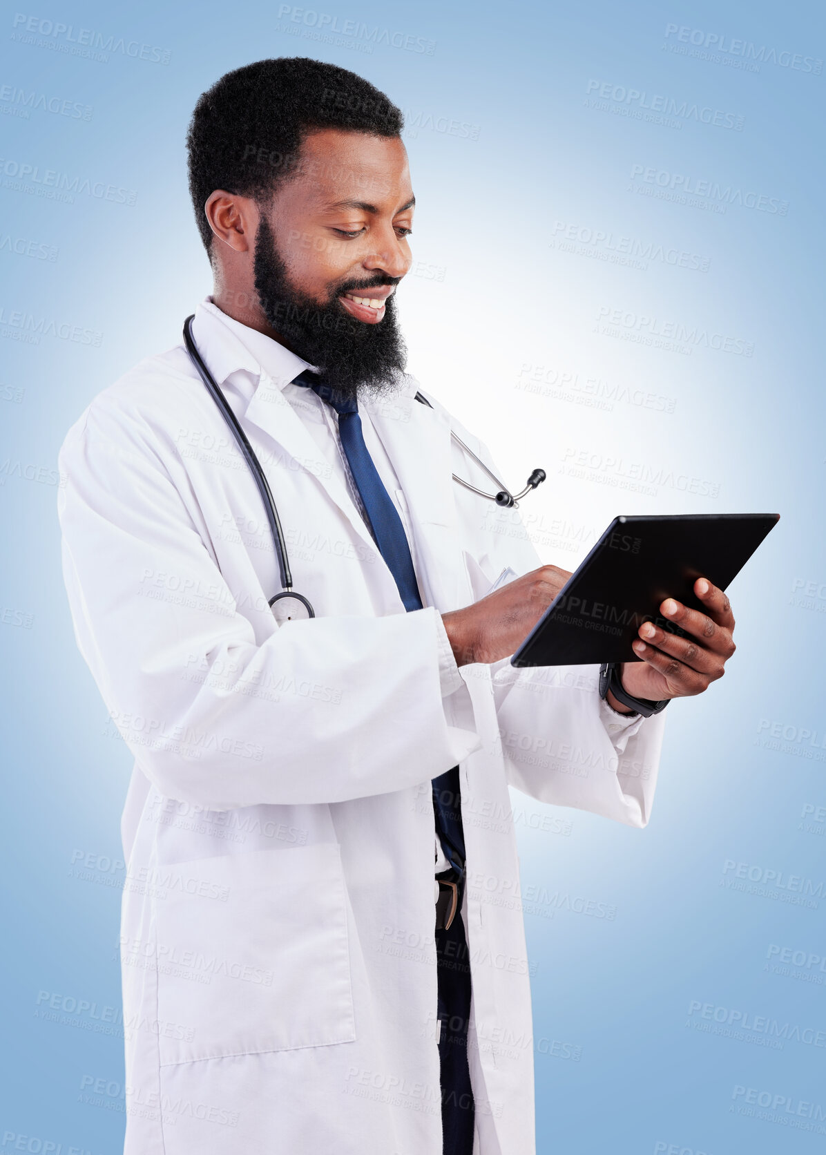 Buy stock photo Medical, tablet and a black man doctor in studio on a blue background for cardiology research. Healthcare, technology and innovation with a male medicine professional searching for information online