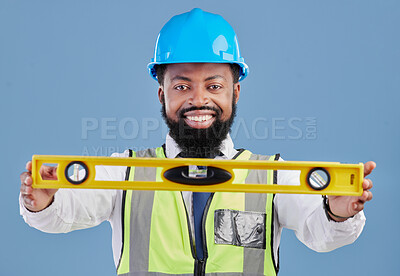 Buy stock photo Happy black man, portrait and architect with level for measuring in construction against a blue studio background. African male person, engineer or contractor smile holding tool for measurements