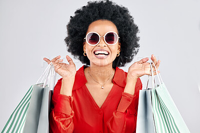 Buy stock photo Happy black woman, face and shopping bags for fashion or style against a white studio background. Portrait of African female person, customer or shopper smile for discount, sale or deal in happiness