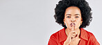 Secret, portrait and black woman with finger on lips in studio for sign of privacy, mockup space and white background. Banner, face and female model shush for noise, mystery news and silence emoji 