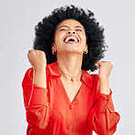 Happy black woman, winner and fist in studio for celebration, achievement and success on white background. Face of excited model celebrate winning prize, deal and victory of lottery, bonus and reward