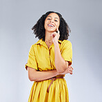 Portrait, fashion and happy with a model woman in studio on a gray background for trendy style. Yellow, smile and beauty with a confident young female person with an afro posing in a clothes outfit