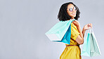 Woman, shopping and excited with bags at retail sale, promotion or happy for discount on studio, mockup or background. Customer, portrait and shop for fashion or sales on luxury clothing