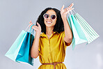 Sunglasses, portrait and woman with shopping bag for fashion in studio isolated on a white background. Face smile, sales and African customer with gift, discount deal and clothes from retail store