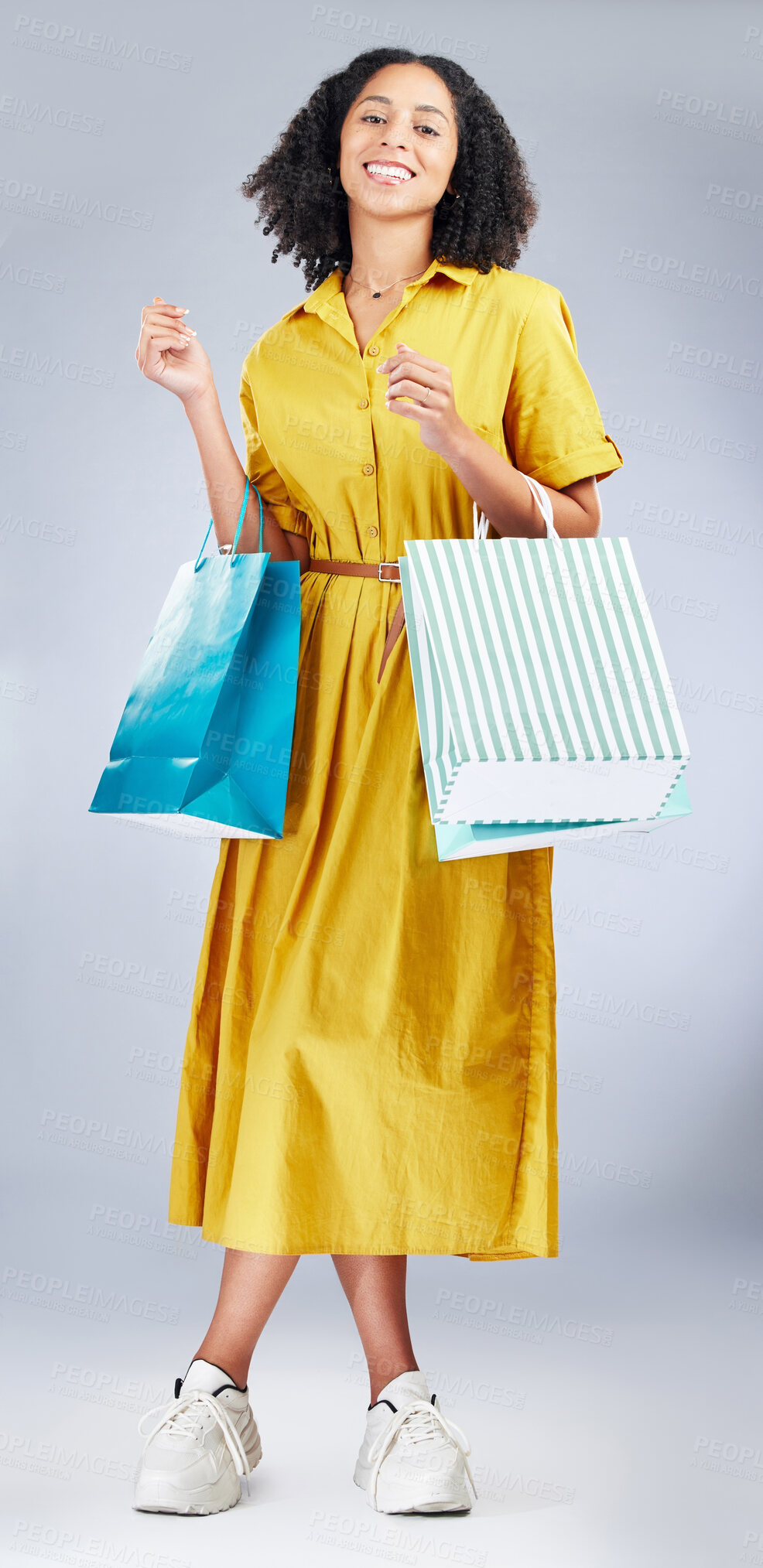 Buy stock photo Portrait, shopping bag and a woman in studio for fashion sale, promotion or retail discount. African female model or happy customer on a white background for advertising commerce offer, deal or gift 