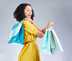 Excited, happy and woman with shopping bag for fashion in studio isolated on a white background. Smile, sales and African customer with gift, discount deal and clothes from shop, mall or retail store