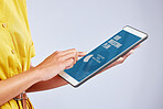 Hands, digital tablet and closeup of a woman in studio reading an ebook on the internet or website. Screen, research and female person scrolling on an online blog with technology by a gray background