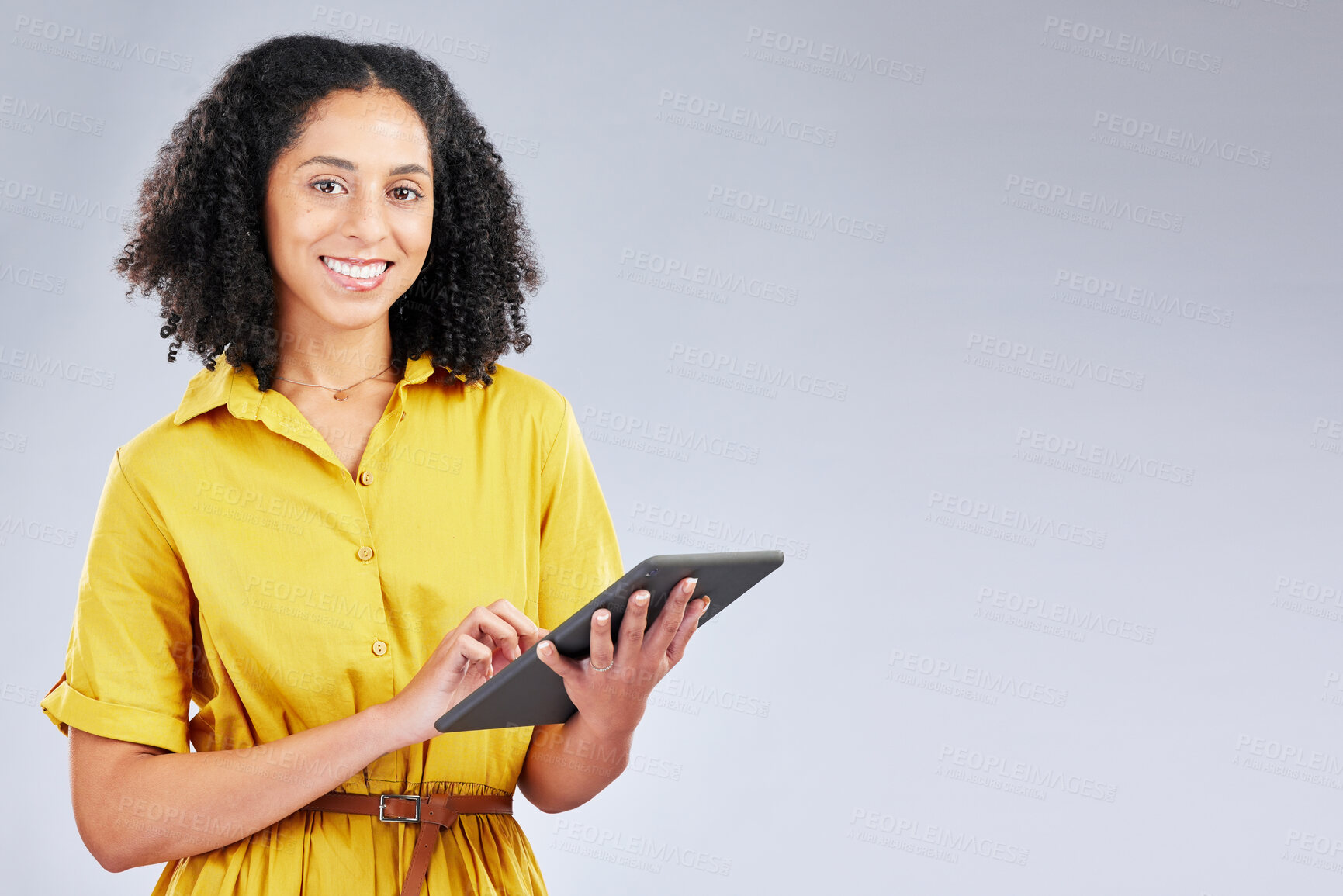 Buy stock photo Smile, email and portrait of a woman with a tablet on a studio background for communication. Happy, work and a young girl or employee typing on technology with mockup space for an app or internet