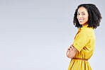 Portrait, fashion and mockup with a model woman in studio on a gray background for trendy style. Yellow, smile and a happy  young female person with an afro posing in a clothes outfit on space
