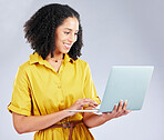 Laptop, typing and business woman for online marketing, social media planning and copywriting research. Editing, blog and creative worker or African person on computer on a white background in studio