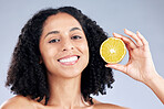 Woman, lemon and skincare in studio portrait with smile, health and nutrition for wellness by background. Girl, African model and fruit for face, cleaning or cosmetics for beauty, self care or change