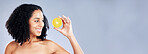 Smile, beauty and a woman with a lemon on a studio background for vitamin c and detox. Happy, nutrition space and a young model with a fruit on a mockup banner for wellness, skincare and health