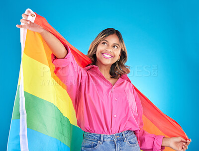 Buy stock photo Lgbtq flag, freedom and woman with support, pride and transgender right on a blue studio background. Female person, lesbian or model with symbol for queer community, equality or celebration with hope