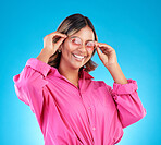 Fashion sunglasses, portrait and happy woman in studio isolated on a blue background. Face, glasses and Indian model with style, designer shades and positive mindset for aesthetic, gen z and smile