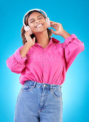 Buy stock photo Young woman, headphones and music, audio streaming service and techno or student podcast in studio. Happy person listening to radio with gen z electronics and wellness on a blue, gradient background