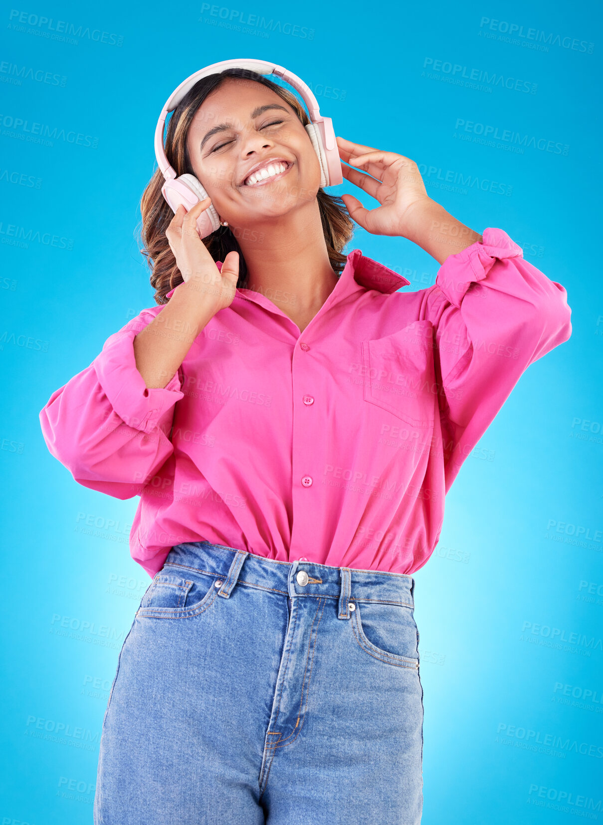 Buy stock photo Young woman, headphones and music, audio streaming service and techno or student podcast in studio. Happy person listening to radio with gen z electronics and wellness on a blue, gradient background