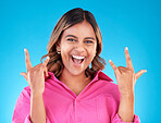 Happy, portrait and woman with rocker hands in studio for freedom, fun and positive attitude on blue background. smile, face and female with rockstar emoji, sign or punk gesture, good mood or vibes