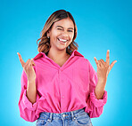 Wink, portrait and woman with rocker hands in studio for freedom, happy and positive attitude on blue background. Smile, face and female with rockstar emoji, sign or punk gesture, good mood or vibes