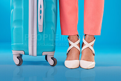 Buy stock photo Closeup, woman and shoes with suitcase, standing and fashion on a blue studio background. Zoom, person and model with luggage, stylish footwear and baggage for travel with human and business trip 