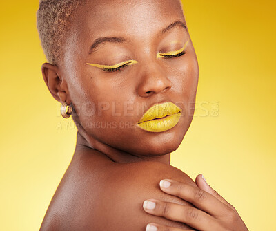 Buy stock photo Creative, makeup and woman in a studio with cosmetic eyeliner and lipstick for cosmetology. Self care, glamour and young African female model with a colorful face routine by a yellow background.