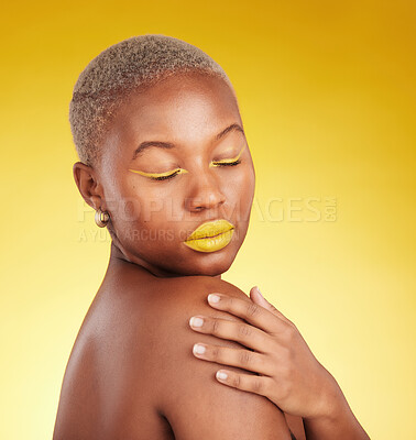 Buy stock photo Beauty, cosmetic and young woman in a studio with eyeliner and lipstick for cosmetology. Self care, makeup and creative African female model with a colorful glamour face routine by yellow background.