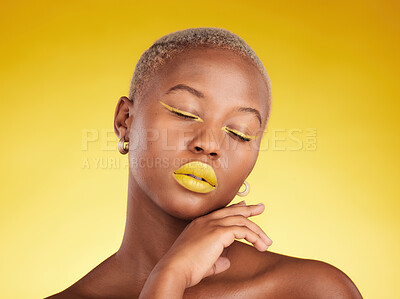 Buy stock photo Face, makeup and lipstick with a black woman in studio on a yellow background for creative, beauty or cosmetics. Gold, color and eyeshadow on young model with eyes closed for fashion or aesthetic