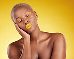 Creative, makeup and face with lipstick or black woman in studio on a yellow background for art, beauty or cosmetics. Gold, color and eyeshadow on calm model sleeping with fashion or aesthetic