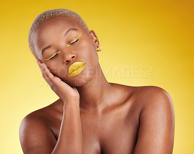 Buy stock photo Creative, makeup and face with lipstick or black woman in studio on a yellow background for art, beauty or cosmetics. Gold, color and eyeshadow on calm model sleeping with unique aesthetic or art