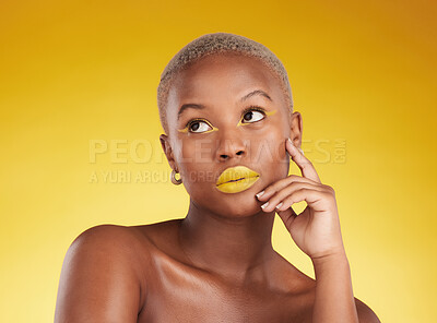 Buy stock photo Thinking, makeup and a black woman on a studio background for creativity or fashion. Ideas, gold art and an African girl or model with yellow lipstick, cosmetics or young beauty on a backdrop
