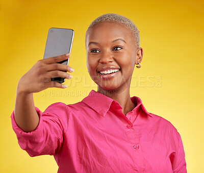 Buy stock photo Smile, selfie and happy black woman in studio isolated on a yellow background. Profile picture, photographer and African person or influencer taking photo for memory, social media or blog on internet