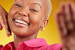 Selfie, smile and african girl with confidence or excited for social media in yellow background studio in closeup. Portrait, happy and face with woman for video call, blog, photography or influencer.