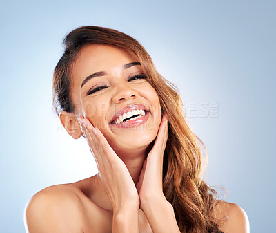 Buy stock photo Laughing, skincare or happy woman in portrait for beauty, wellness or anti aging in studio on blue background. Natural facial routine, funny girl or face of model with smile or healthy glowing skin 