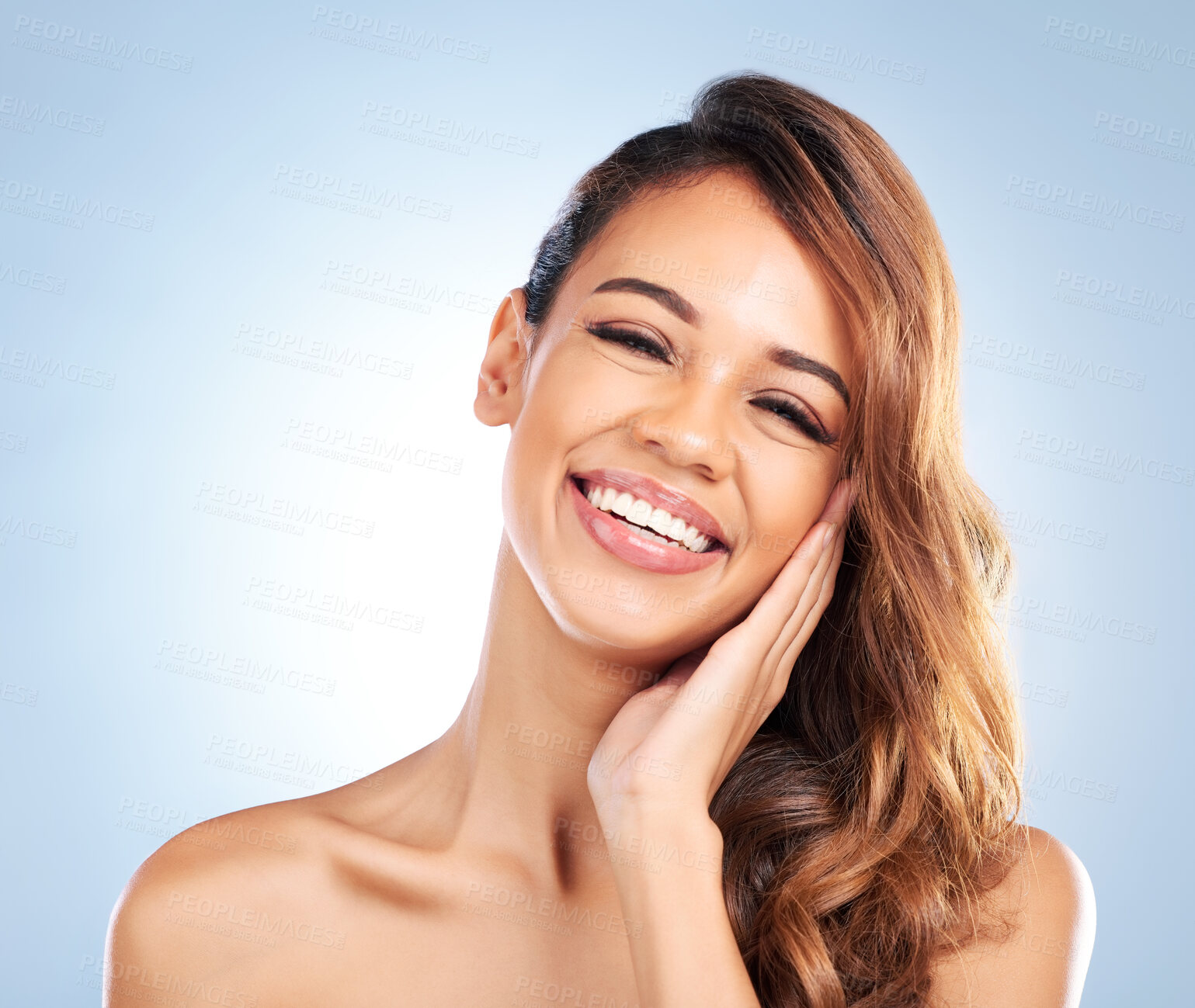 Buy stock photo Happy woman, portrait and face in skincare for beauty, haircare or cosmetics against a blue studio background. Female person or model touching perfect skin in satisfaction for spa or facial treatment