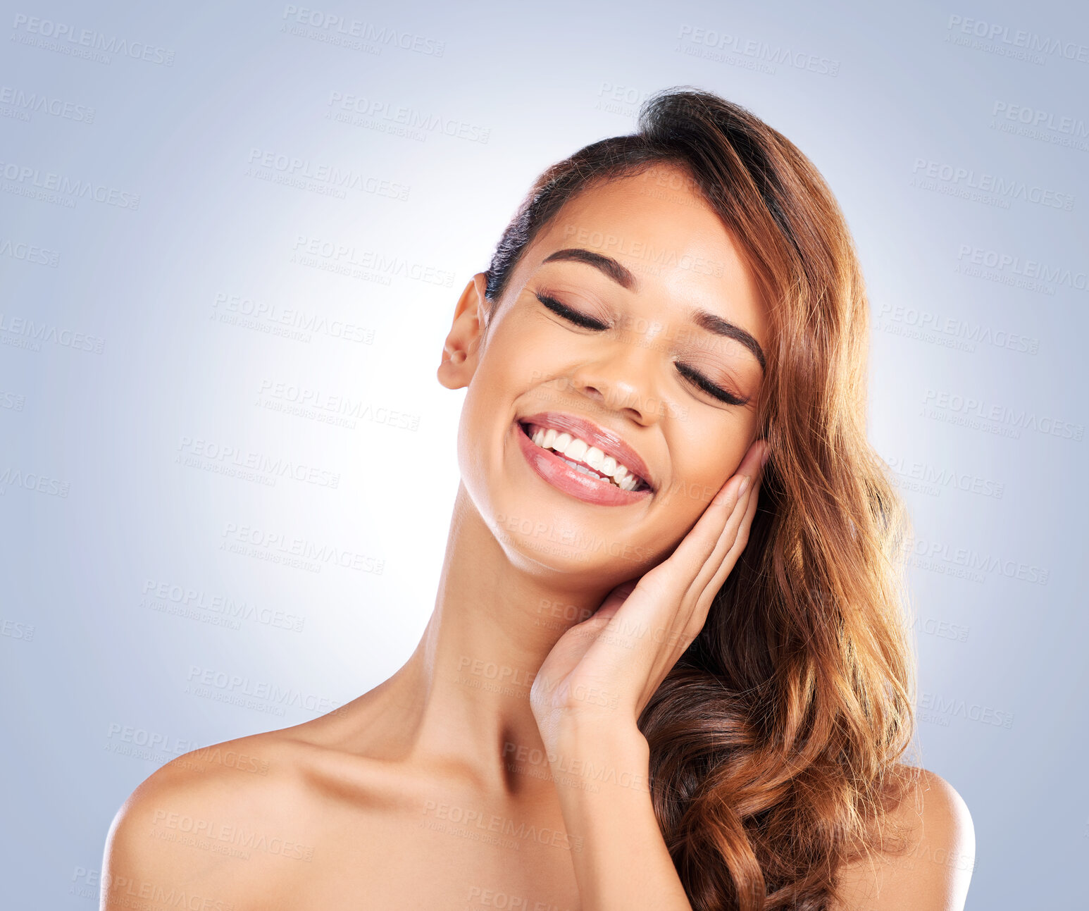 Buy stock photo Happy woman, face and skincare for natural beauty, haircare or cosmetics against a blue studio background. Female person smile and touching perfect skin in satisfaction for spa or facial treatment