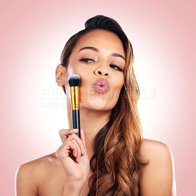 Buy stock photo Beauty, kiss and face of woman with makeup brush on pink background for salon, wellness and luxury. Cosmetology, aesthetic and female person with tools for foundation, cosmetics and glamour in studio