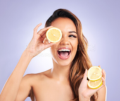 Buy stock photo Vitamin c, lemon and eye of woman with detox, natural or organic beauty isolated in a purple studio background. Excited, happy and young female person with vitamin c for healthy skincare or wellness