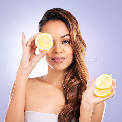 Vitamin c, lemon and eye of woman with healthy, natural or organic beauty isolated in a brown studio background. Excited, happy and portrait of young female person with citrus for skincare or detox