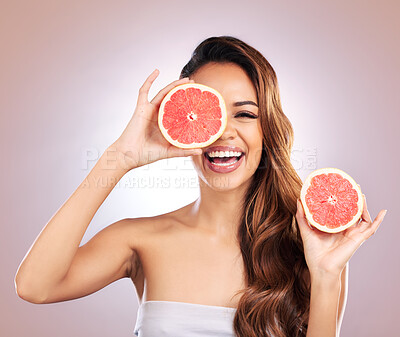 Buy stock photo Vitamin c, grapefruit and portrait of woman with healthy, natural or organic beauty isolated in a brown studio background. Excited, happy and young female person with citrus for skincare or detox
